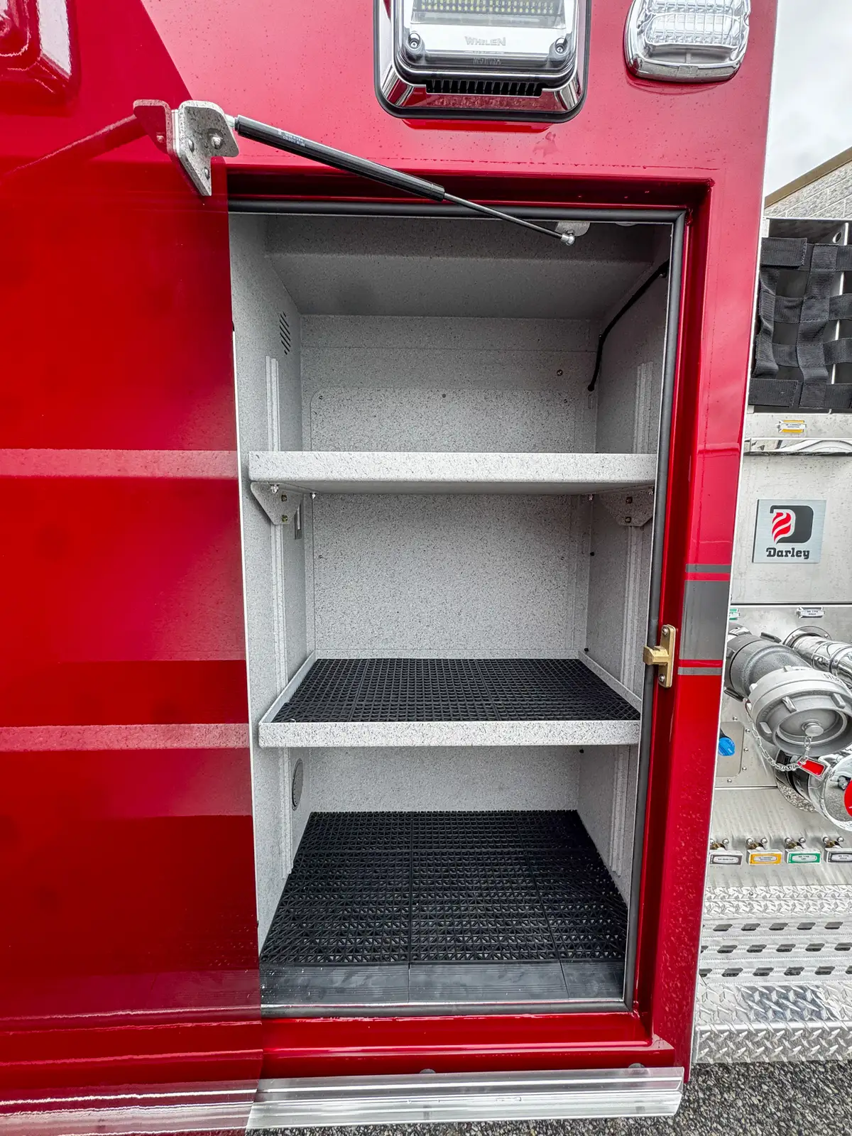 Interior view of open side compartment with upper and lower shelf levels.